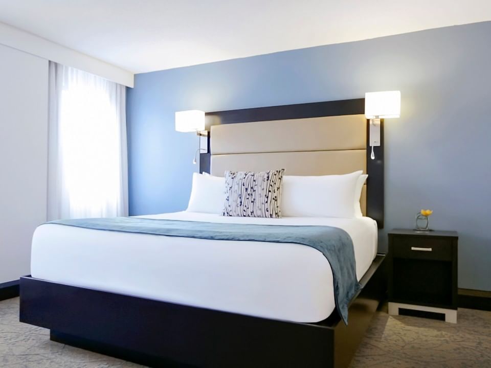 room with king bed and wall lamps