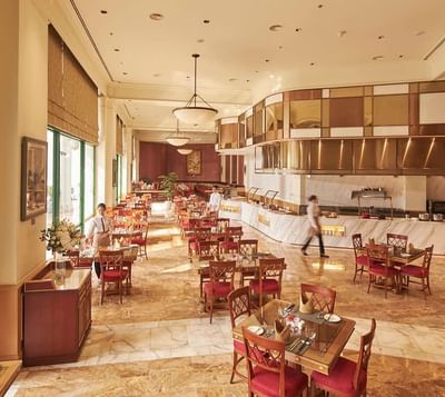 Dining area arranged with tables & chairs at Hanoi Daewoo Hotel