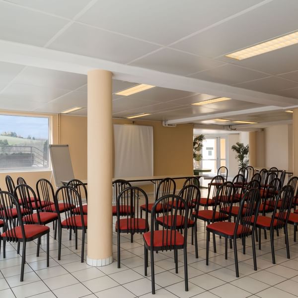 A Meeting room arranged with chairs at Originals Hôtel