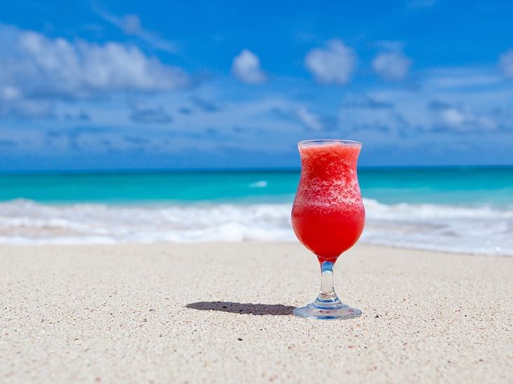 Red frozen cocktail on beach sand near Boulan South Beach Hotel