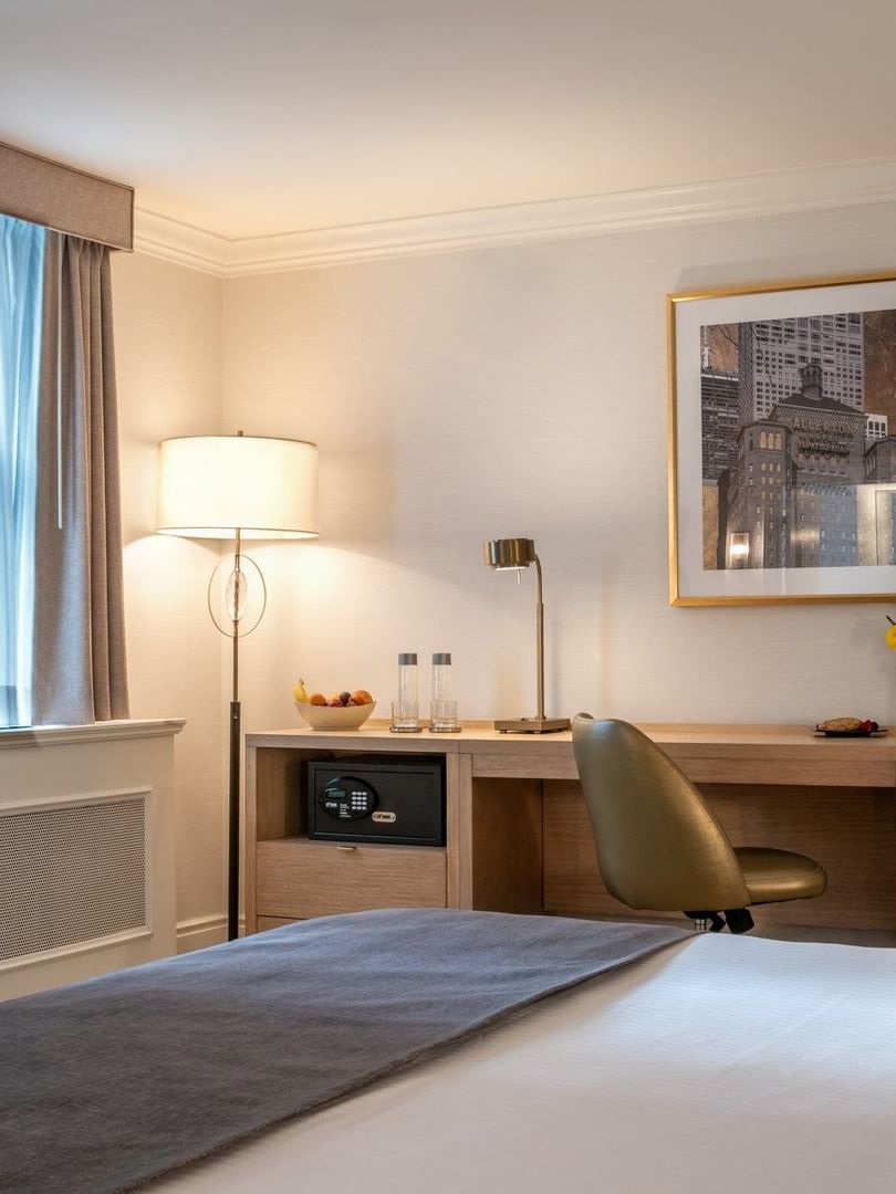 Hanging TV facing the bed with a work desk in King Room at Warwick Allerton Chicago