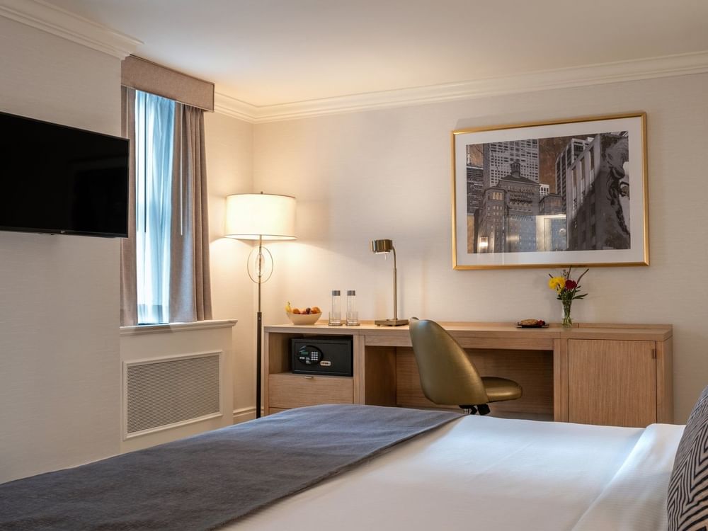 TV facing the bed with a work desk near the window in King Room at Warwick Allerton Chicago