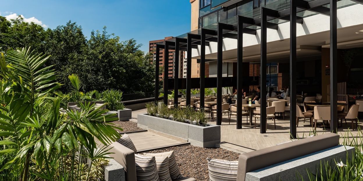 Tables setup outdoors at Nomade Medellin at Blue Doors Hotels
