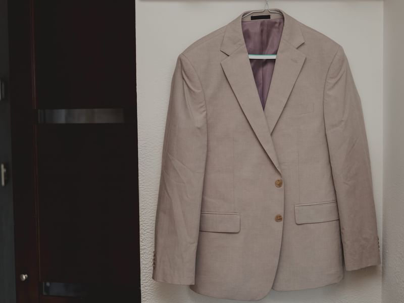 Beige suit jacket hanging on a white wall at Fiesta Americana Riviera Nayarit Resort & Spa.