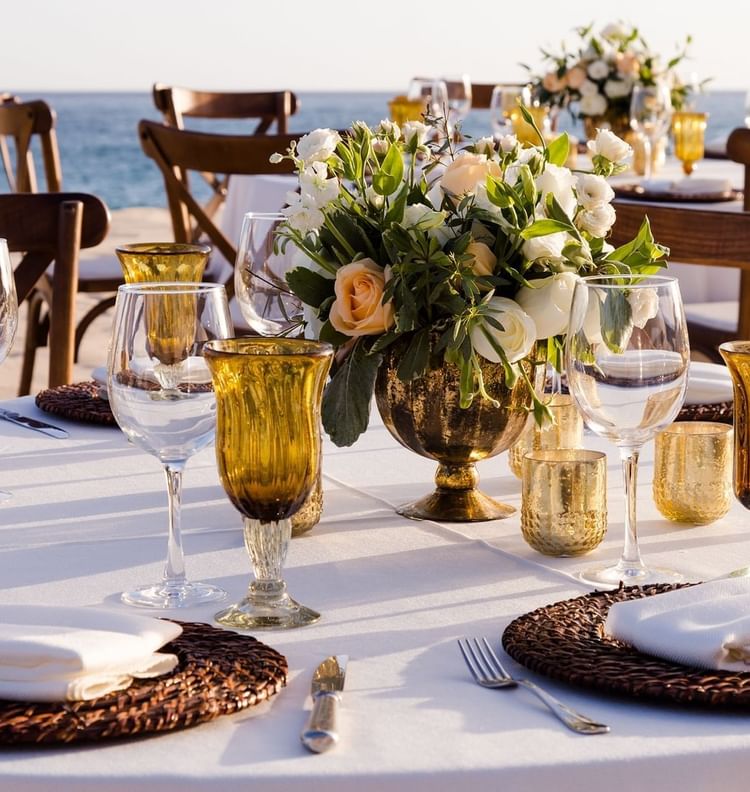 Arranged dining table at the beach at Marquis Los Cabos Resort & Spa
