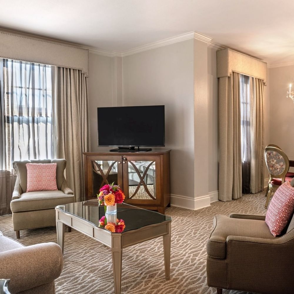 Elegantly furnished Deluxe Suite with modern decor and a living area at Warwick Melrose Dallas.