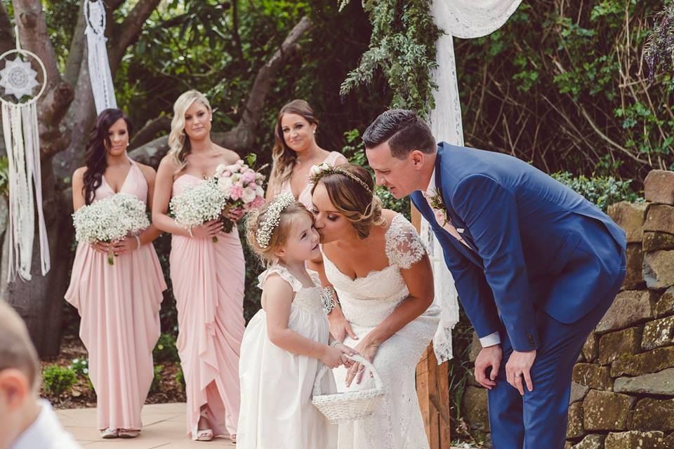 Bride kissing the flower girl in wedding at Mercure Gerringong