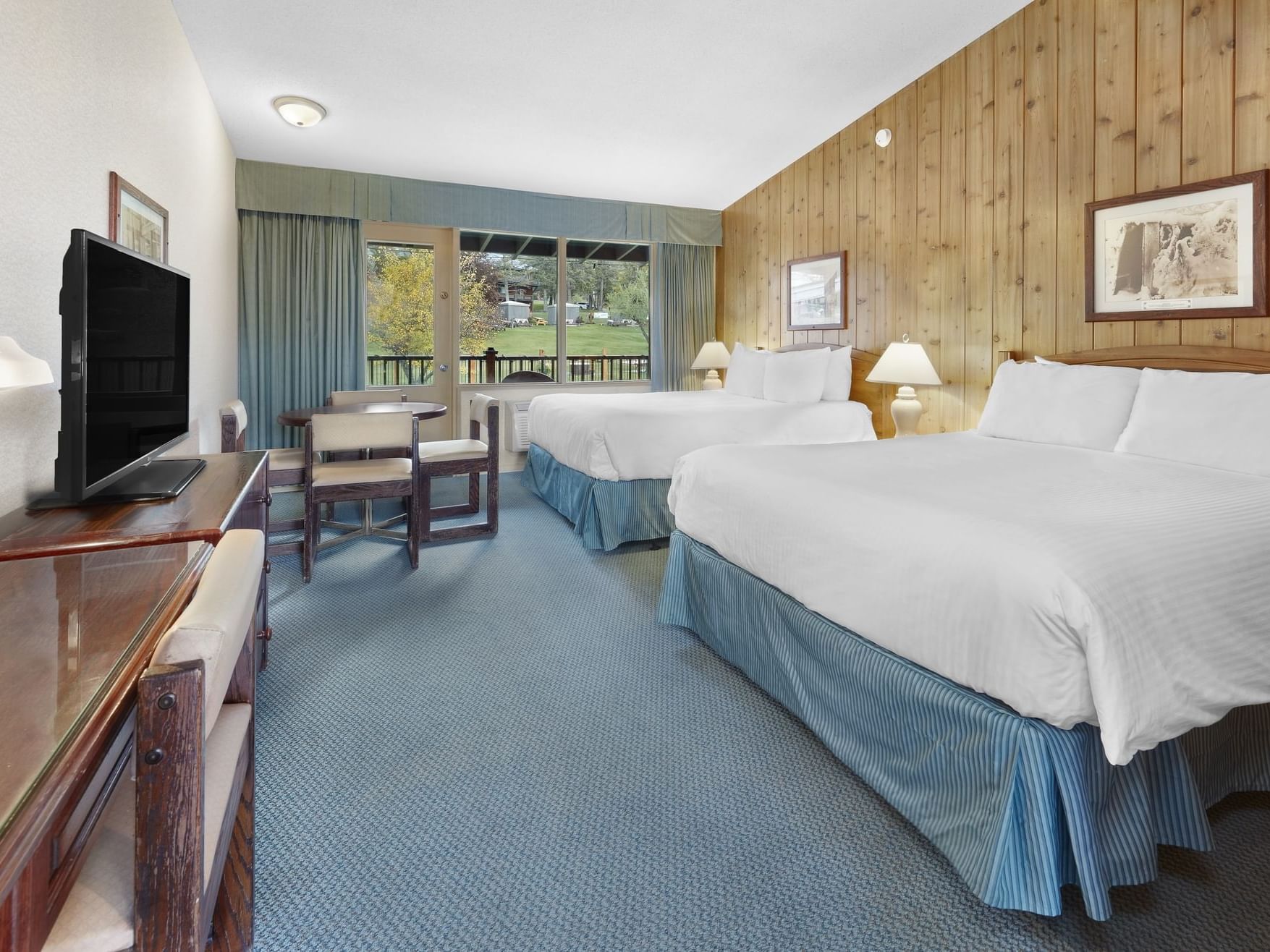 Cozy beds and a TV in Juniper Standard with Kitchenette at Fairmont Hot Springs Resort