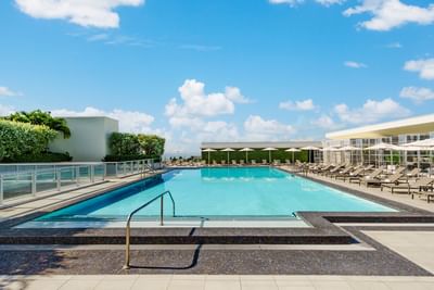 Pool area with canopies & loungers at Costa Beach Resort