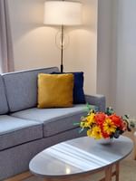 Sofa with coffee table near floor lamp in Executive Two Queen Beds at Warwick Allerton Chicago