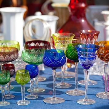Colorful crystal glassware display in Mauerpark Flea Market near Titanic Hotels in Berlin