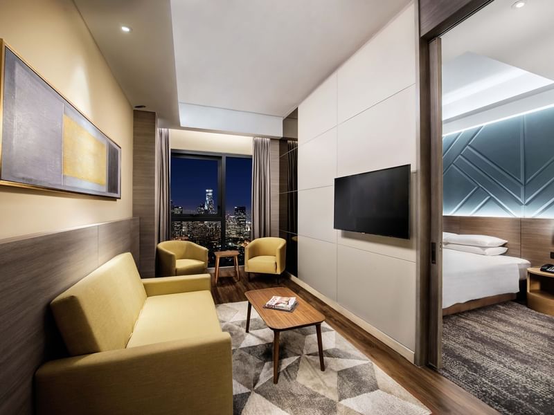 King-size bed and TV in A Basic One Plus King at Sunway Putra Hotel