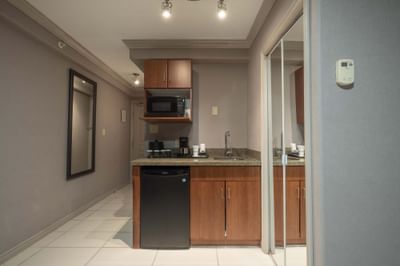Compact kitchenette with microwave, fridge and coffee maker in Jacuzzi Suite at Sandman Hotel & Suites Winnipeg Airport