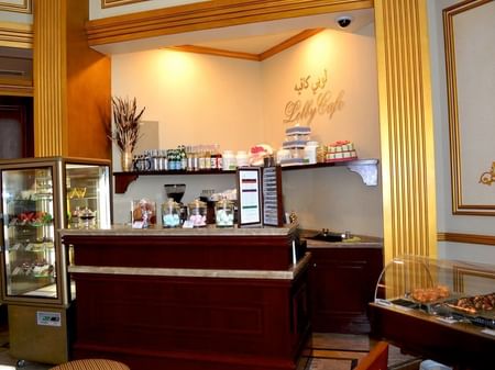 Interior of lobby Cafe with display case at Warwick Doha