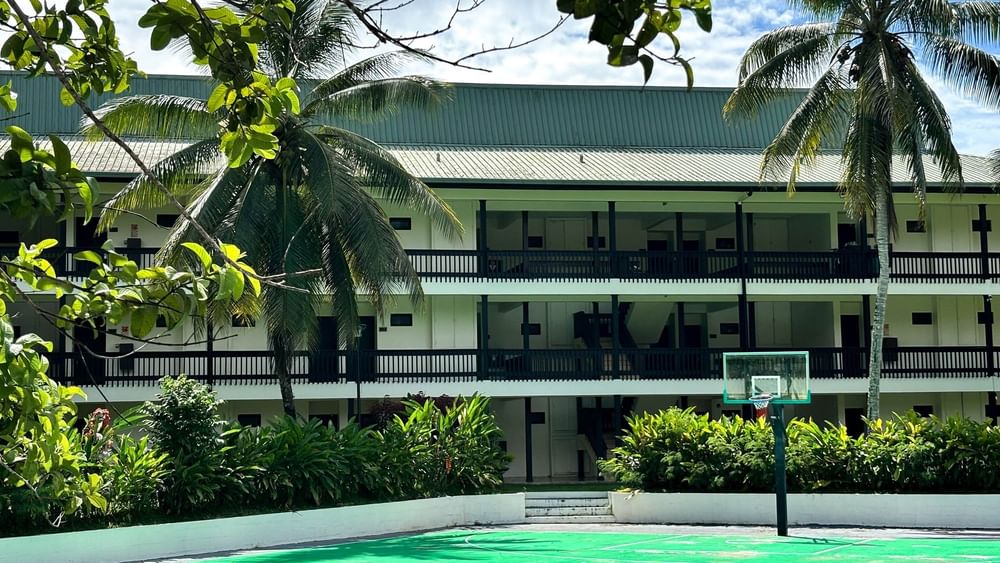 Green sports court with a basketball hoop at The Naviti Resort in Korolevu.