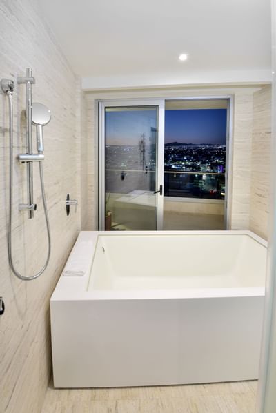 Bath tub with a window at Cabo Villas Beach Resort