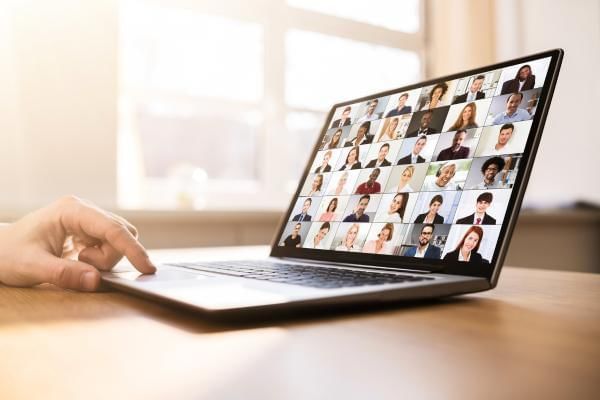 Person pressing mute whilst not speaking at meeting, part of Online Meeting Etiquette