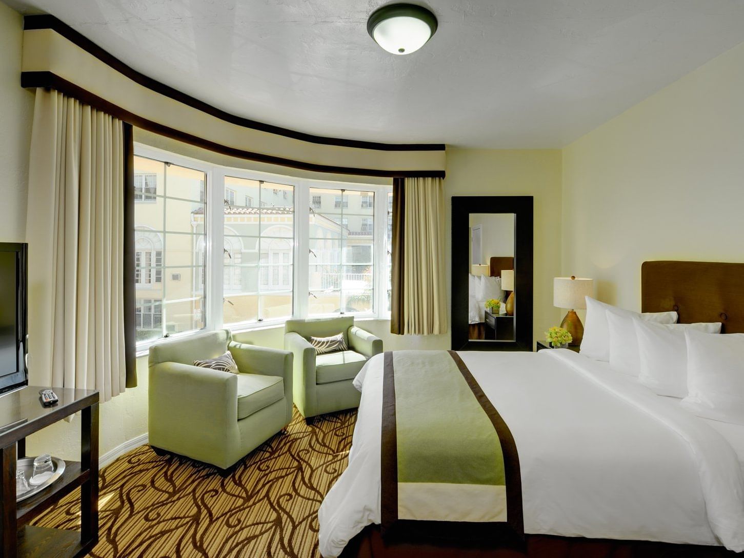 A view of Premium King with one king bed and two couch at Essex House by Clevelander
