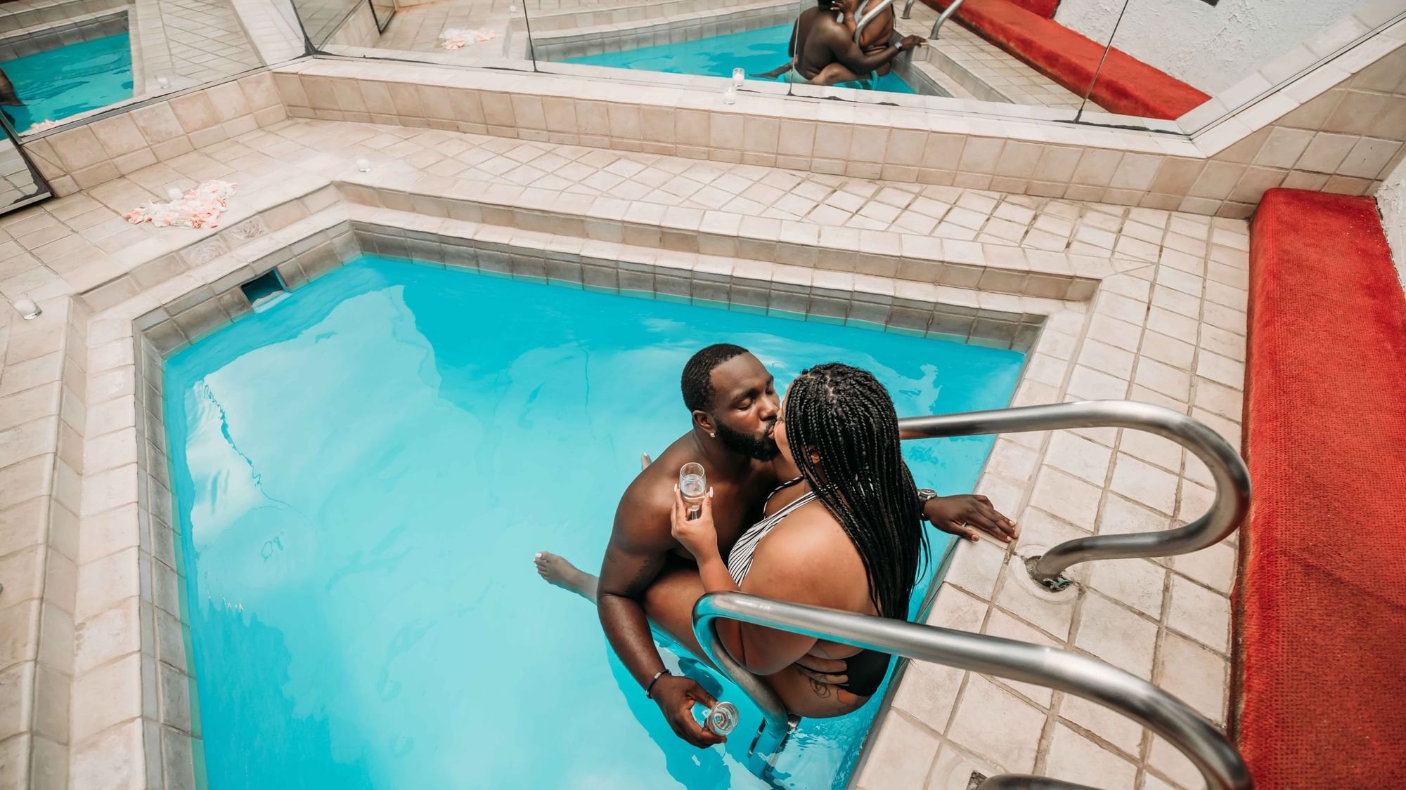 Romantic couple in the Garden of Eden Apple swimming pool at Cove Pocono Resorts