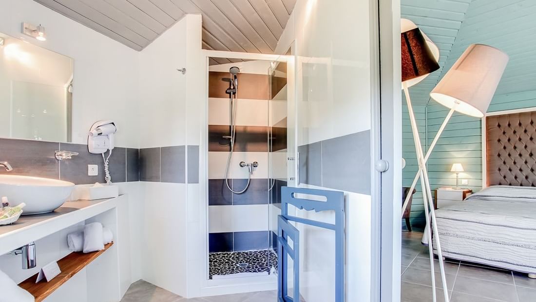 Bathroom vanity and shower area in Junior Suite Double at Roc e Fiori