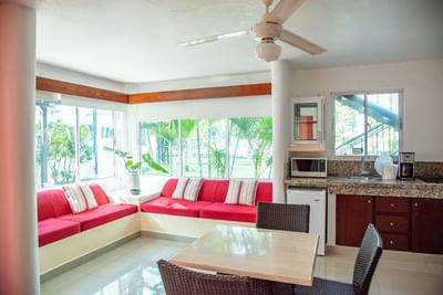 Spacious living area with a dining table in Double Twin Room at Cha Cha Hotel