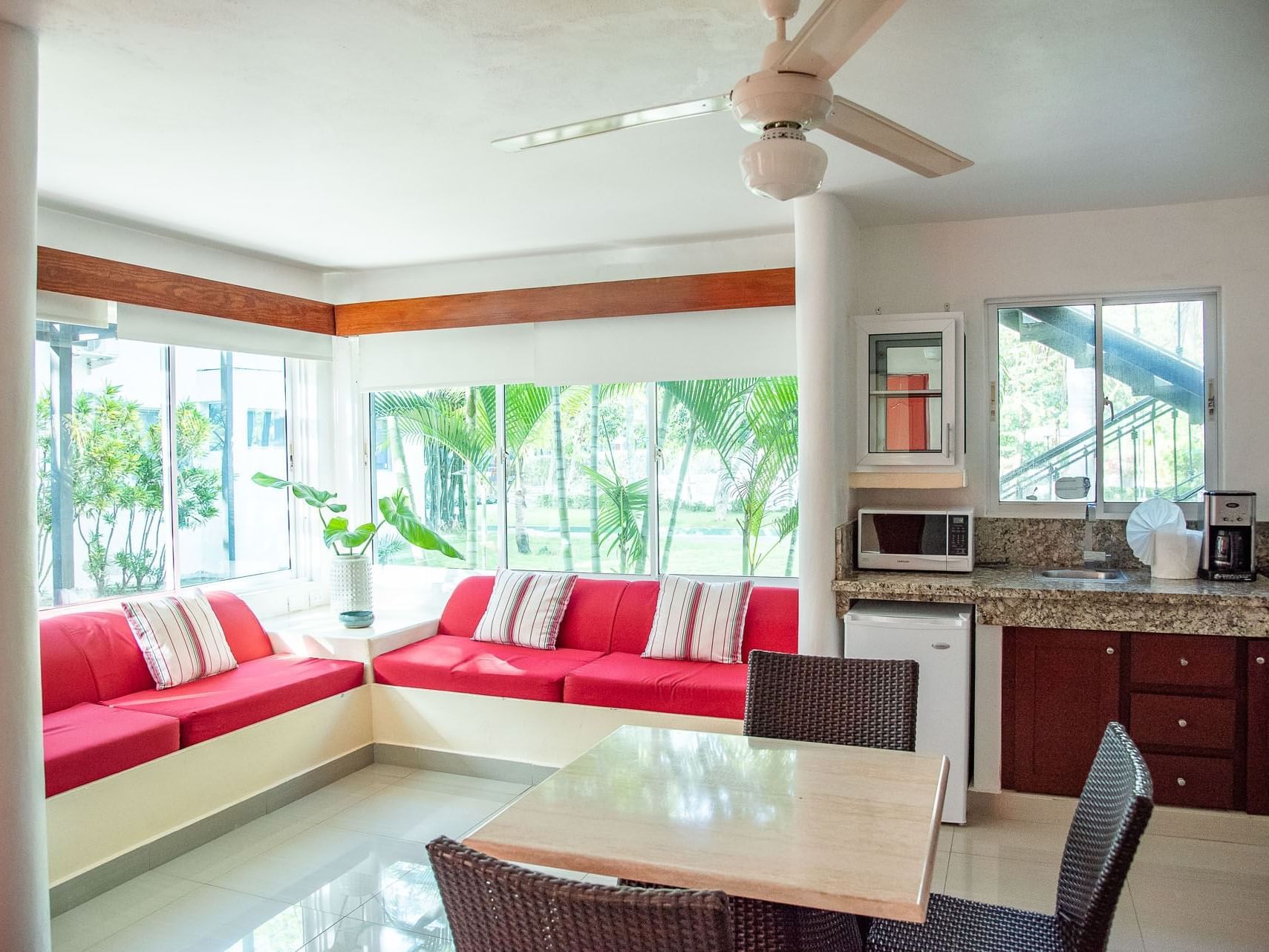 Spacious living area with a dining table in Double Twin Room at Villas Codevi