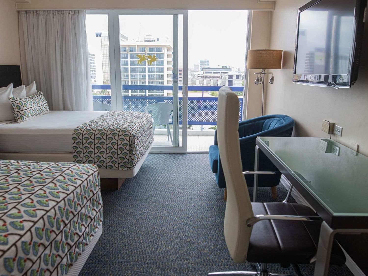 Beds facing work desk in Deluxe Double Room at Jamaica Pegasus Hotel, featuring stylish rooms at a hotel in Kingston Jamaica