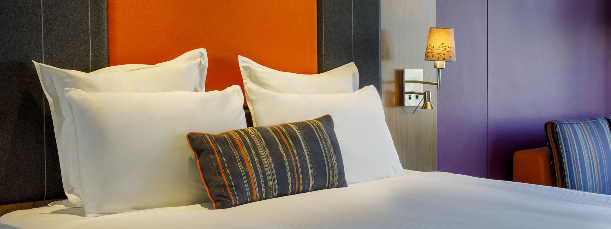 Comfy bed with a cushioned headboard in Classic Room at Pullman Sydney Hyde Park