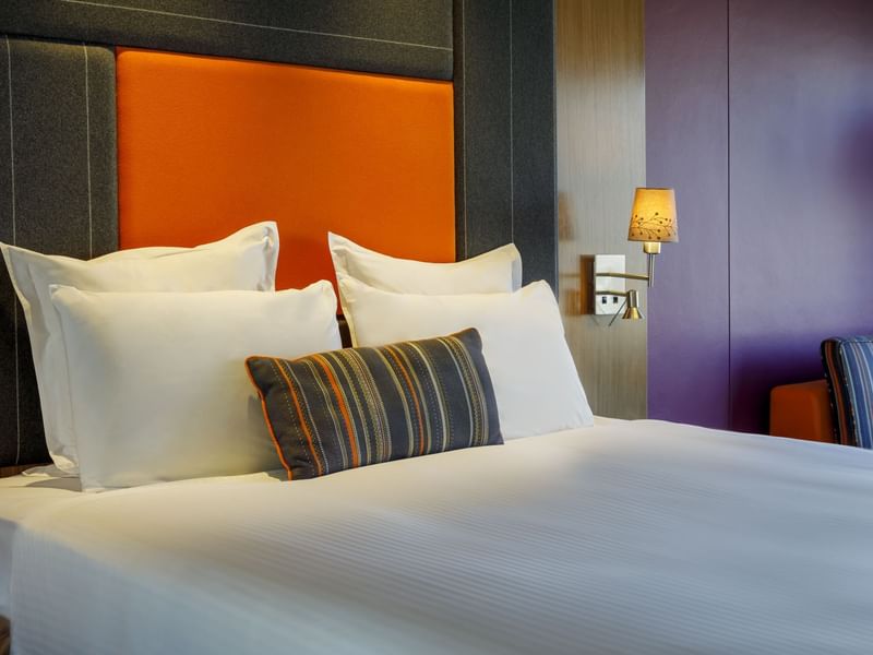 Comfy bed with a cushioned headboard in Classic Room at Pullman Sydney Hyde Park
