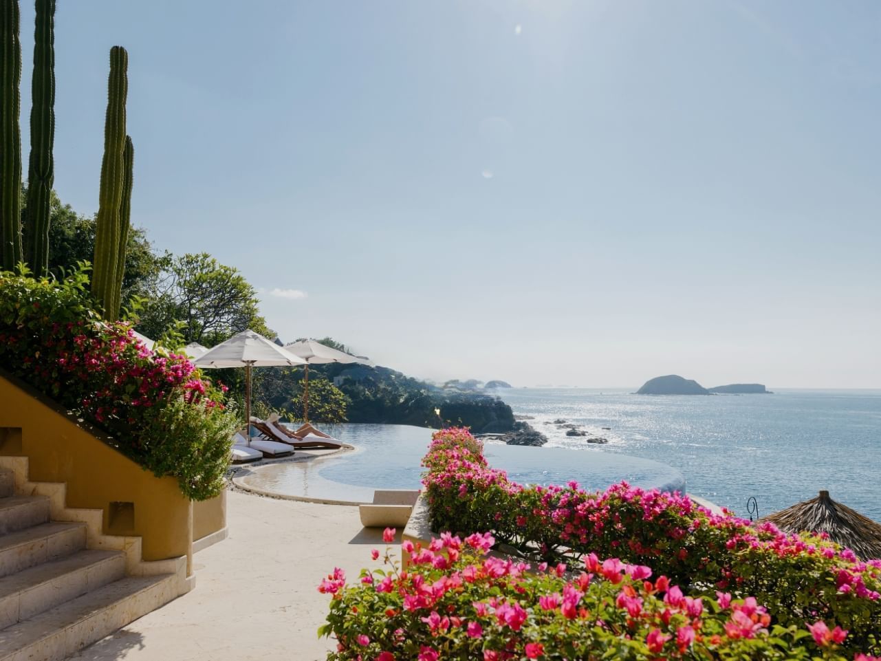 Outdoor pool with ocean view & sunbeds at Cala de Mar Resort