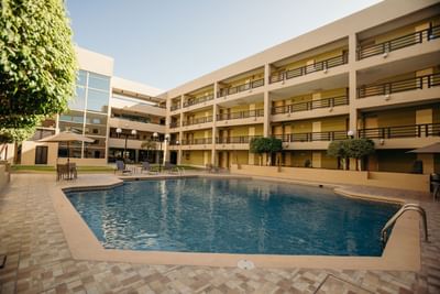 Outdoor pool area with loungers at Araiza Hotel Hermosillo