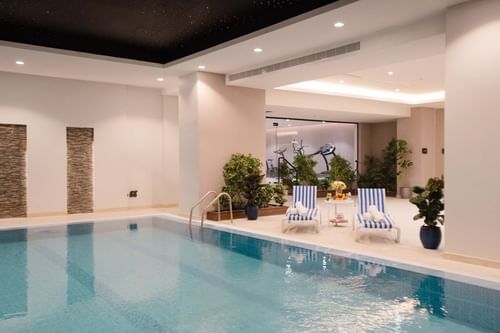 Comfy lounge area with Indoor Swimming Pool at Cantonal Hotel by Warwick Riyadh