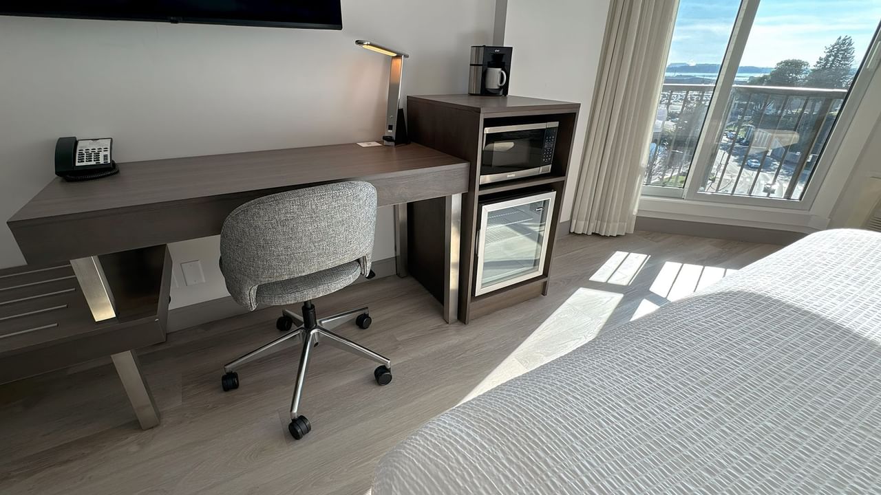 Hotel guestroom with work desk and a chair