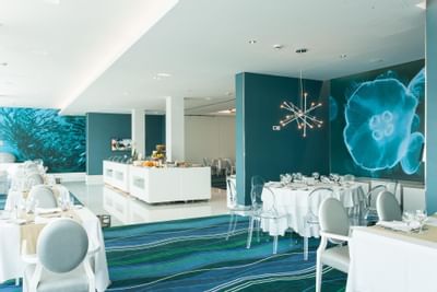 Buffet spread by dining area in Restaurant Presidente with carpeted floors at Hotel Presidente Luanda