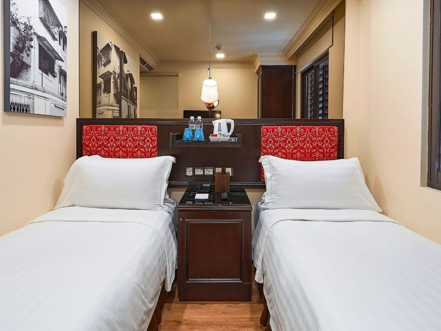 Nightstand & lamp between twin beds in Superior Twin at Nostalgia Hotel Singapore