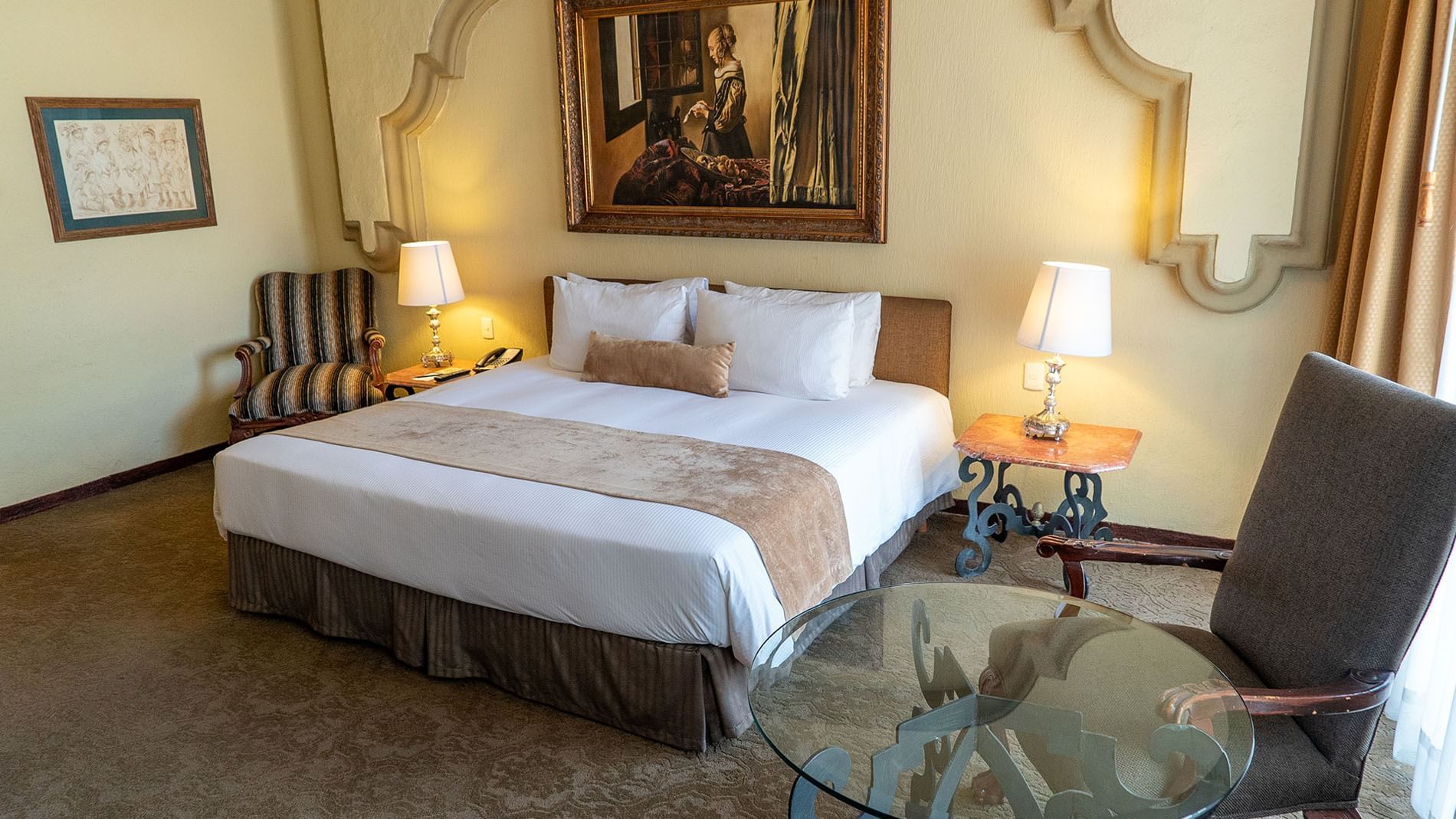 King Master Suite featuring a king bed and classic oil painting at Quinta Real Aguascalientes