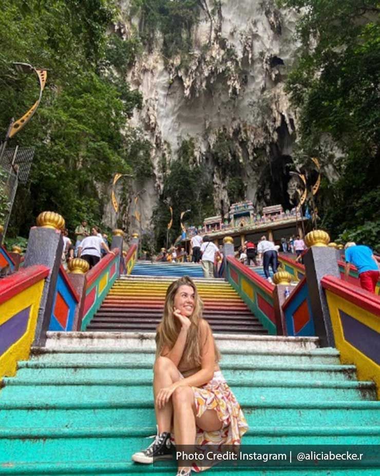 Lady sitting on the stairs in Batu Caves, a famous place near Imperial Lexis Kuala Lumpur