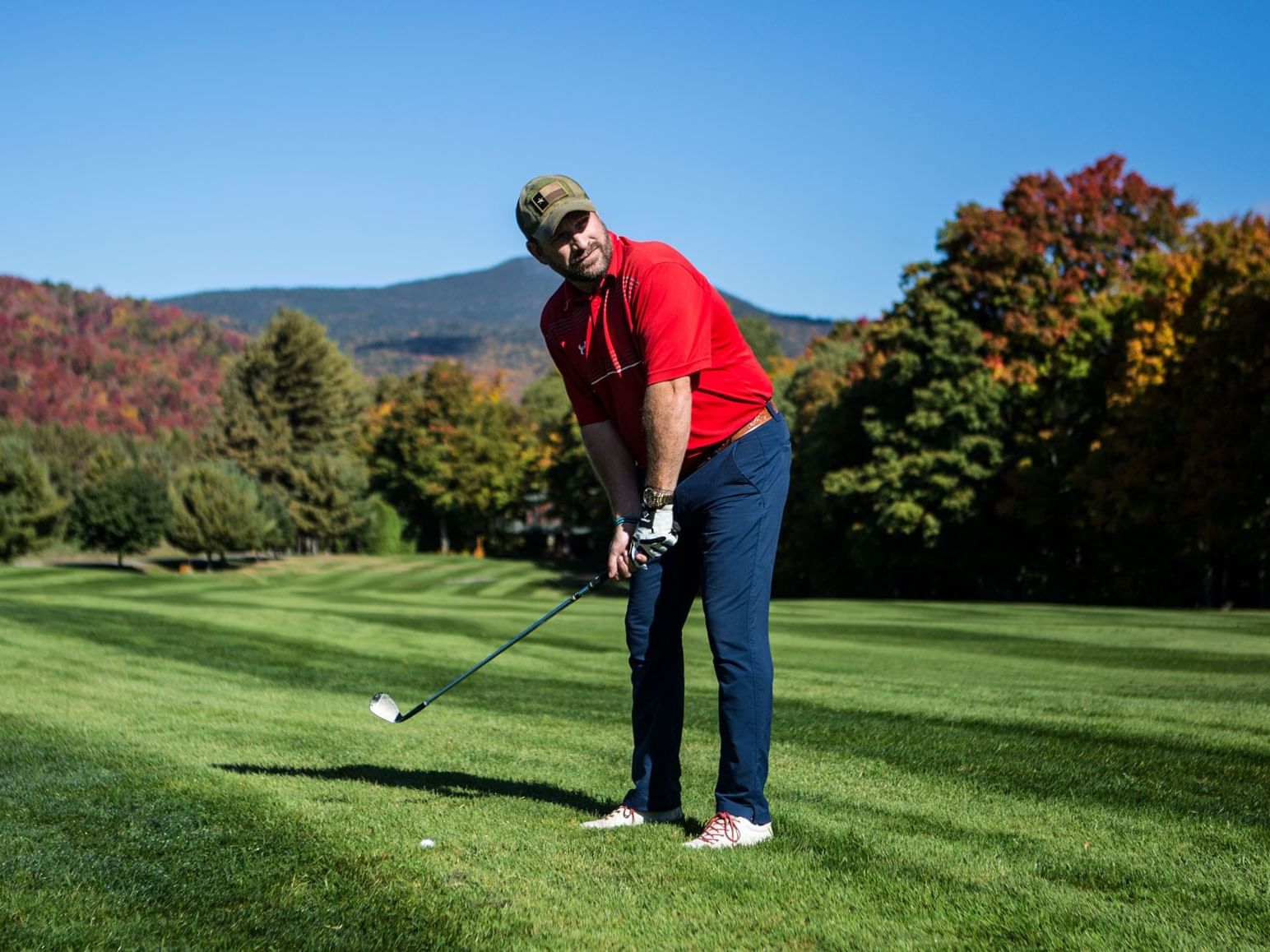 Man playing golf at Whiteface Club near High Peaks Resort