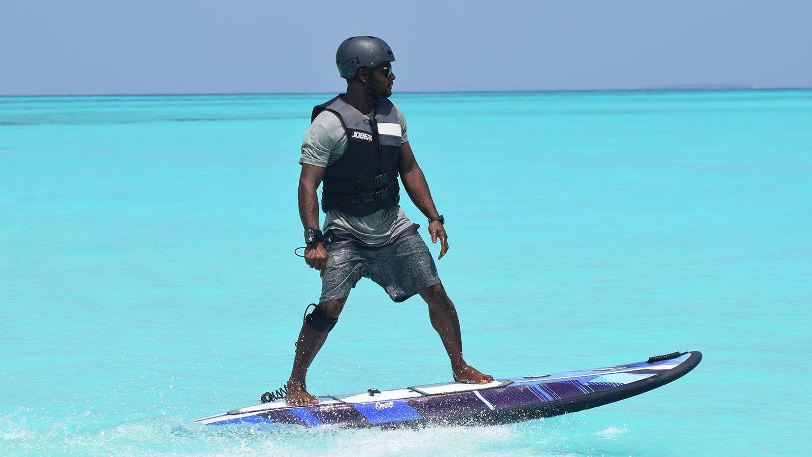 A surfer on E-surfing in the sea near The Signature Collection