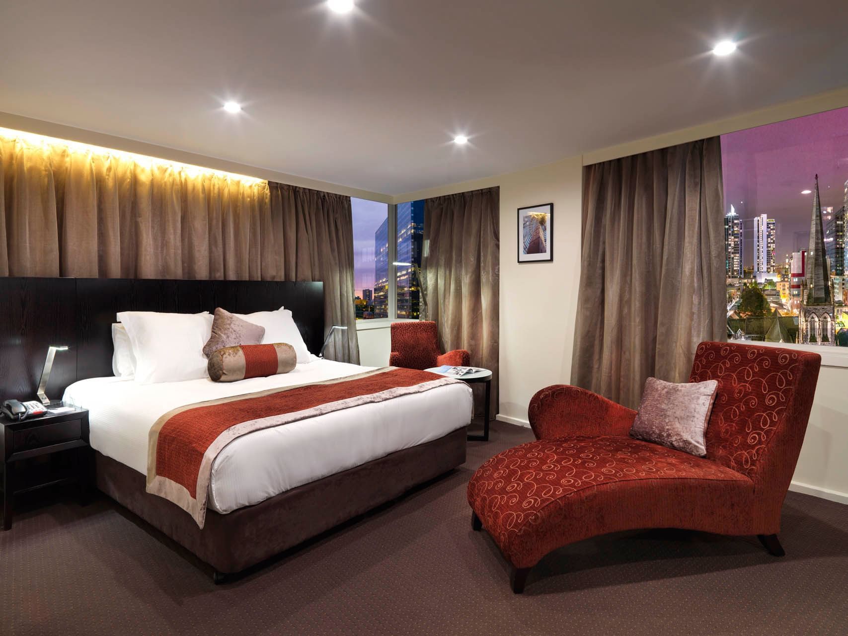 Modern work area and a cozy bed in Premier King at Hotel Grand Chancellor Melbourne