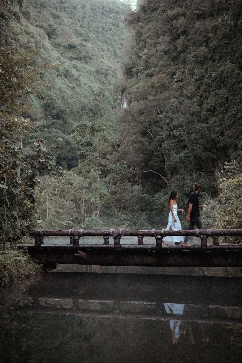 Couple walking on a bridge at The Banjaran Hotsprings Retreat