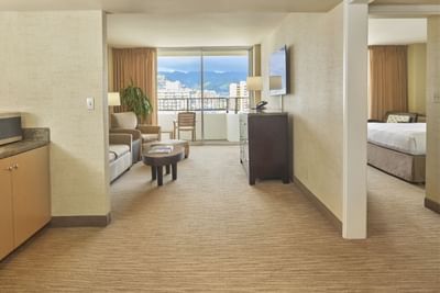Spacious living area with furniture in One Bedroom Mountain View Suite at Waikiki Resort Hotel by Sono