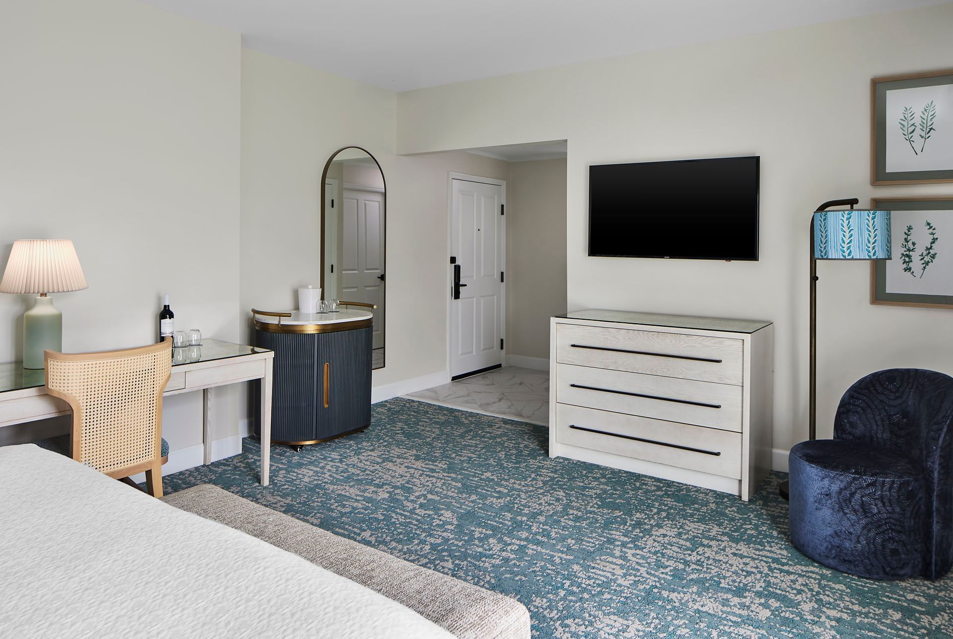 A stylish and comfortable Inn at Celebration guest room with a desk and large white dresser for hotels in celebration FL