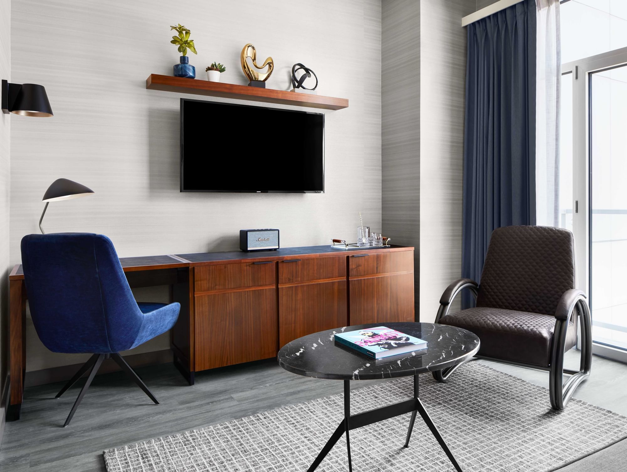 Suite living room with desk chairs and TV