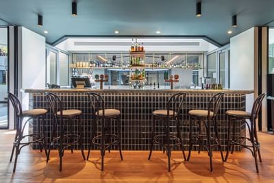 Stools by the counter in the Hotel Bar at Amora Hotel Melbourne