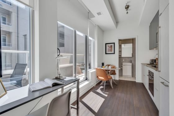 Kitchenette with workspace and large window in Junior Suite with Balcony at ReStays Ottawa