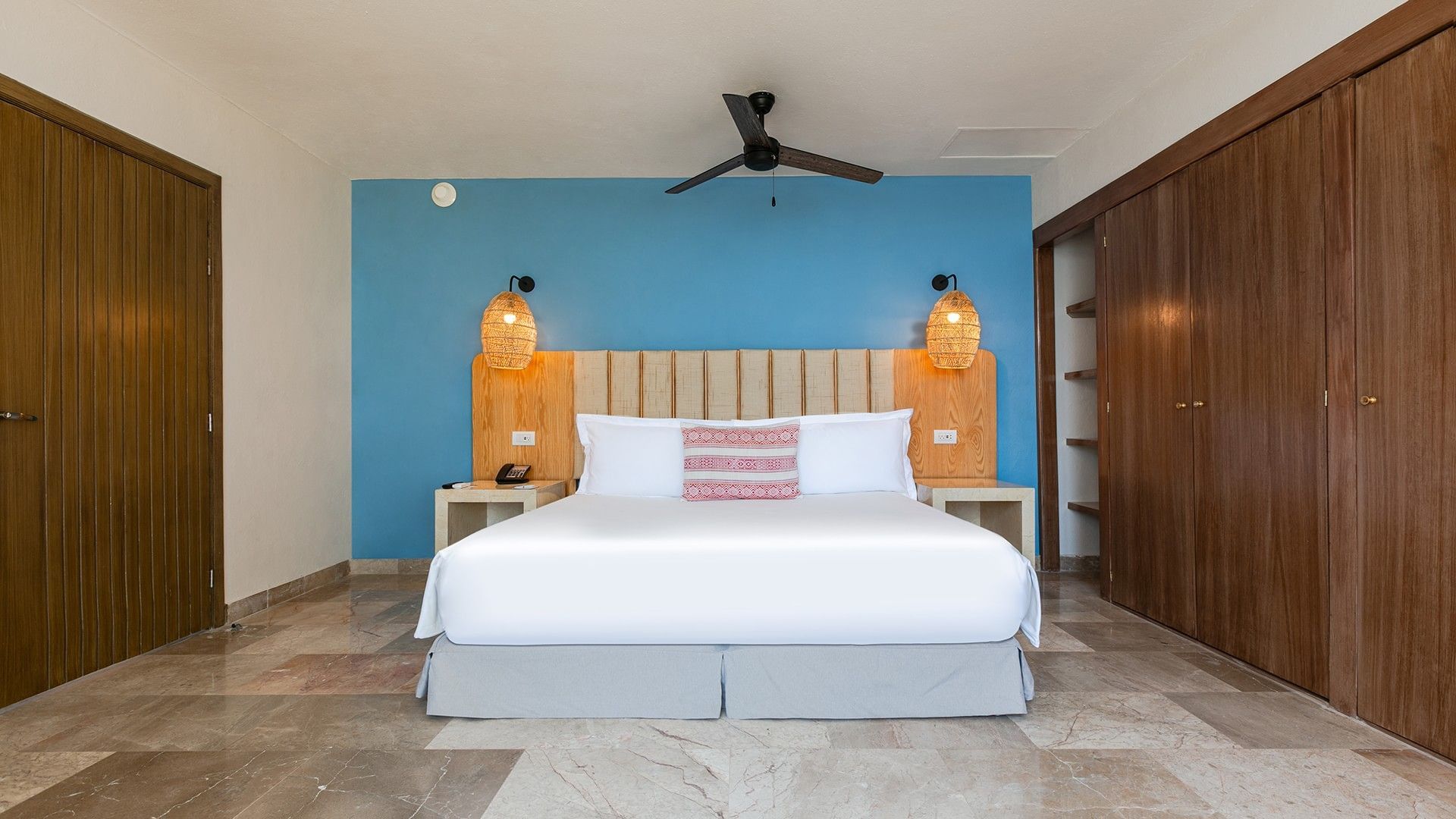 King Presidential Suite with a king bed, blue wall, wooden closet, and marble tile floor at Camino Real Acapulco Diamante