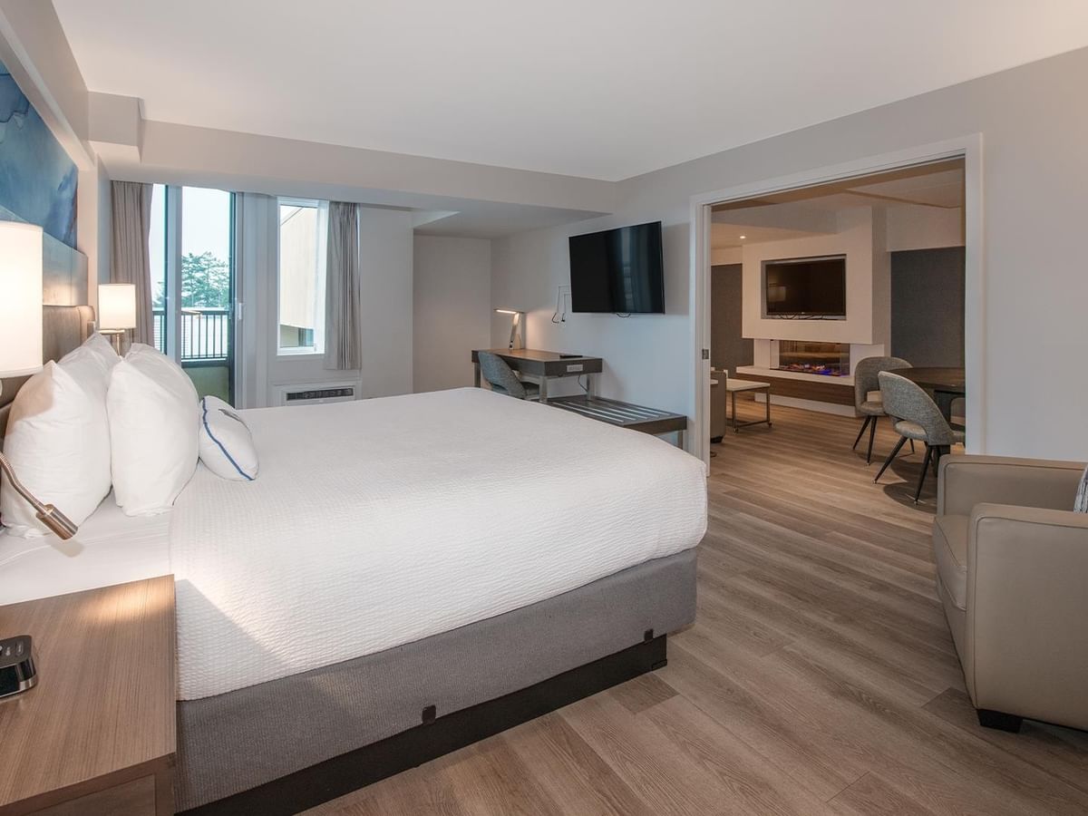 King bed, chair, desk, and TV in Coast Premium King One Bedroom Suite at Coast Bastion Hotel in Nanaimo.