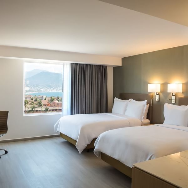 Twin beds in Superior Room with city view at Fiesta Inn