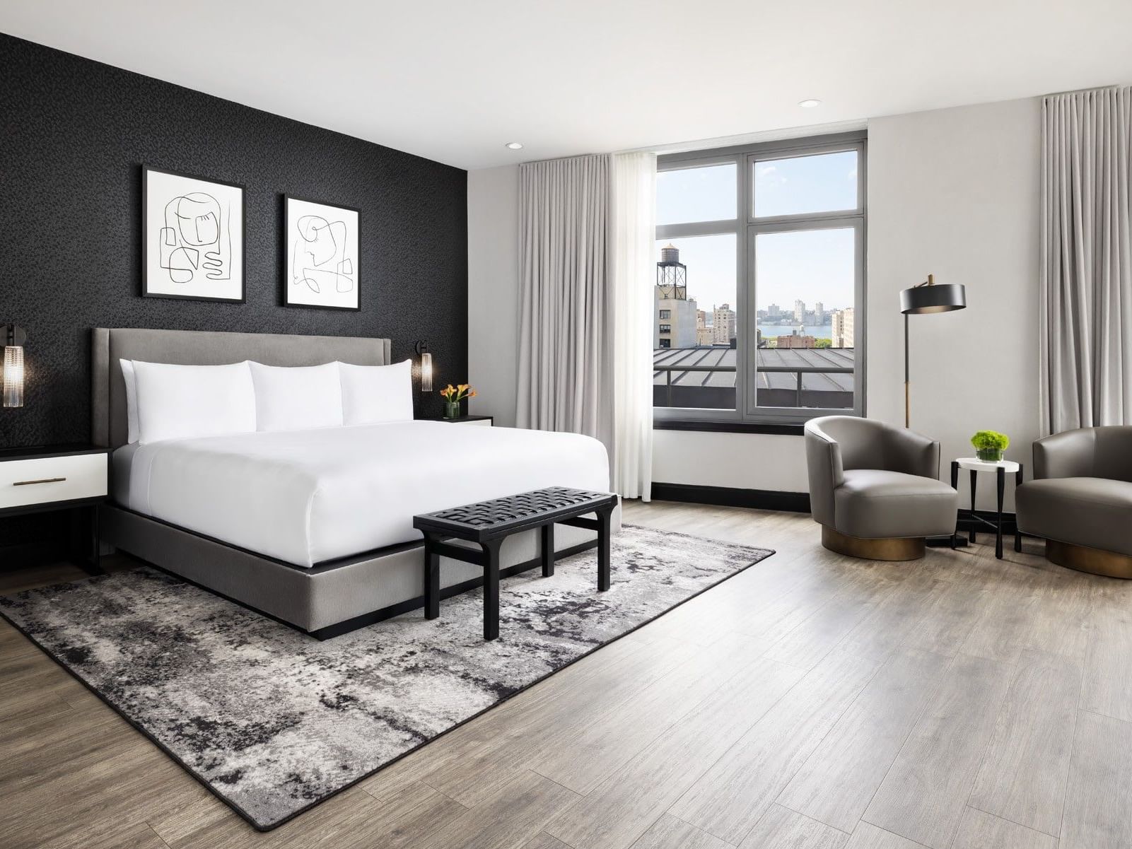 Loft With Terrace featuring a king bed, seating area, and city views at ArtHouse Hotel New York City.